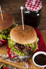 Close-up of home made burgers, wooden desk background