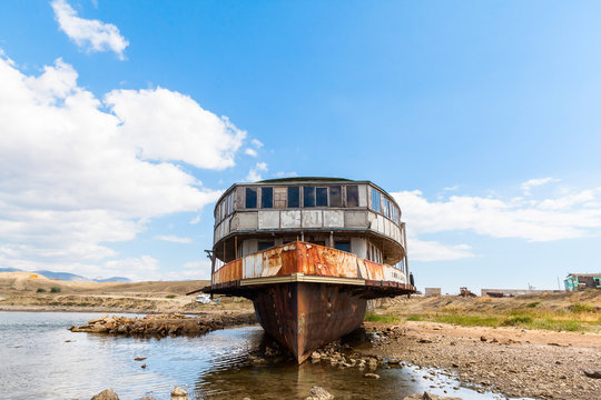 old rusty wheel steamship on the sea shore