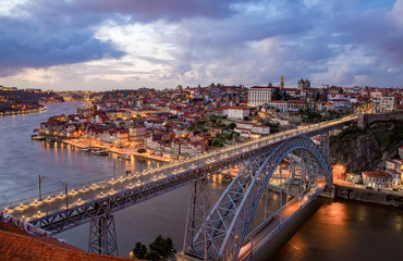 Fototapeta na wymiar View of the historic city of Porto, Portugal with the Dom Luiz bridge at dusk.