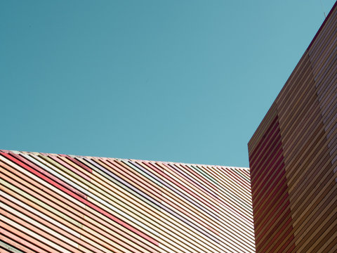 Building with diagonal lines against clear blue sky