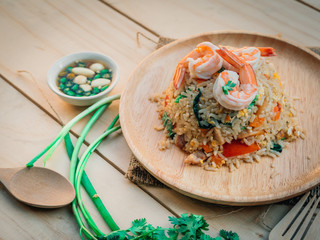 Vintage style Traditional Thai food Fried rice with shrimp on top able plan on wooden background wallpaper