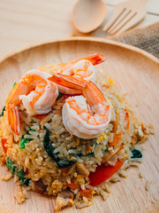 Vintage style Traditional Thai food Fried rice with shrimp on top able plan on wooden background wallpaper
