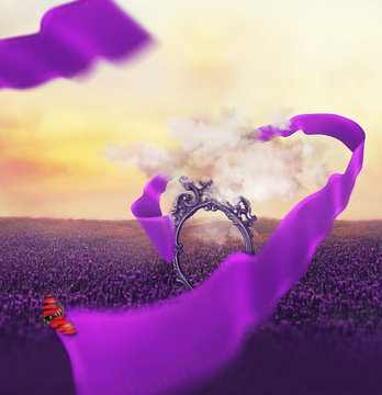 Colorful creative painting effect photo manipulation with antique mirror through a cloud and flying curved ribbon with a ladybud at lavender fields with beautiful sunset sky