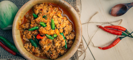 Vintage style Thai traditional food roasted chili paste with chicken and shrimp hot and spicy on top able on wooden background wallpaper