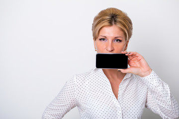 Fototapeta premium Young business woman shows on your phone