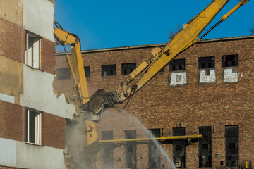 Demolitions old building in center city with heavy equipment
