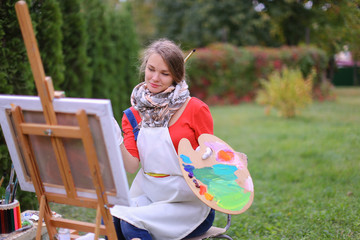 Women beautiful painter posing and smiling, laughing into camera