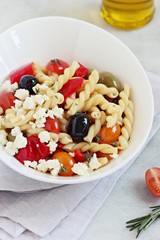 Pasta salad with fresh vegetables and feta cheese. Selective focus