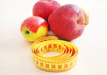 fresh red apples with tape measure - weight loss - diet concept