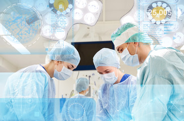 Fototapeta premium group of surgeons in operating room at hospital