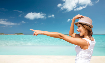 Fototapeta na wymiar happy young woman in hat on summer beach