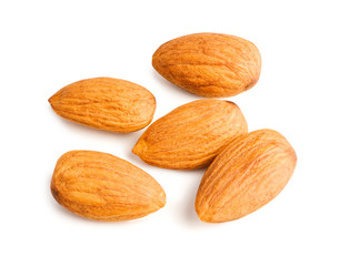 Five almonds nuts isolated on white background with clipping path. Top view. Macro.