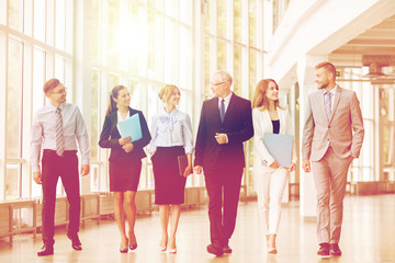 business people walking along office building