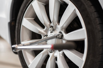 Obraz na płótnie Canvas screwdriver and car wheel tire