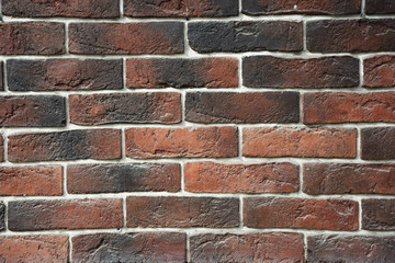 Fototapeta premium The texture of the walls with dark red brick