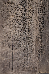 Crosses carved on the outworn wall of the Christian monastery
