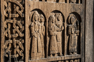 Wooden door details in Tatev monastery with figures and abstract ornaments