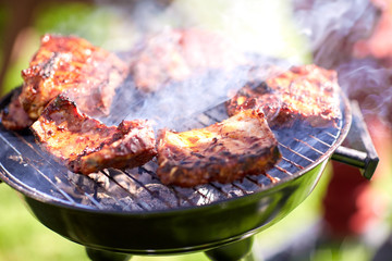 meat cooking on barbecue grill at summer party
