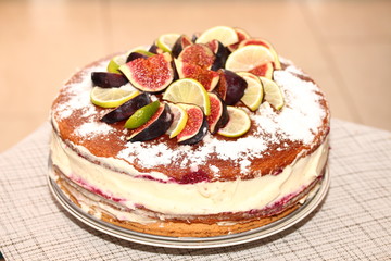 Tasty rustic biscuit cake with figs, lemons and limes slices.