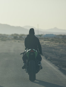 Person on motorbike on remote road