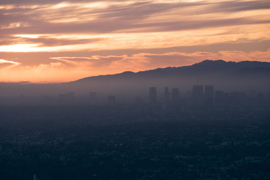 View of cityscape during fogy weather in sunset
