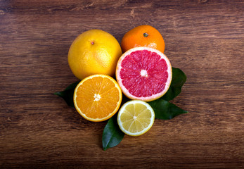  citrus fruit (slice lemon, slice orange, slice grapefruit and tangerine) with leaves  
