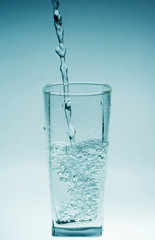 Glass of pouring water