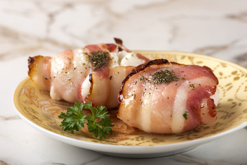 Baked goat cheese wrapped in smoked bacon