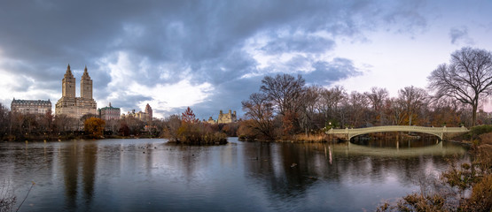 Panorama of The Lake,  Bow Bridge and buildings in Central Park - New York, USA