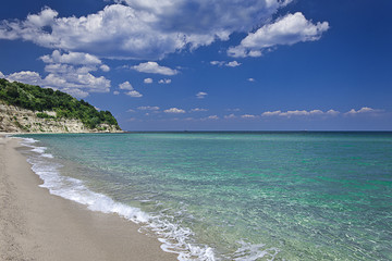 Wild beach with clear water and blue sky in summer