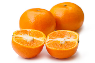 Three tangerines on a white