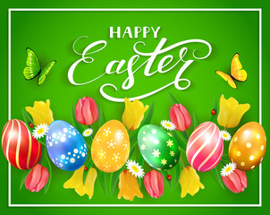 Easter eggs and flowers on green background