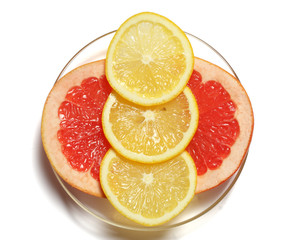 Slices grapefruit and lemon on white