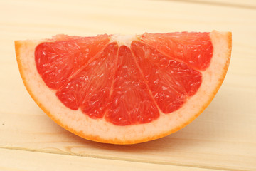 pieces of grapefruit on wood on white