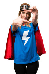 Pretty superhero girl focusing with her fingers