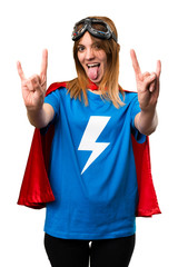 Pretty superhero girl making horn gesture