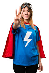 Pretty superhero girl counting three