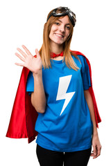 Pretty superhero girl saluting