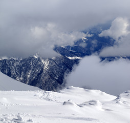 View on winter snowy mountains in clouds