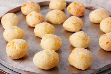 Brazilian snack cheese bread (pao de queijo) on oven-tray