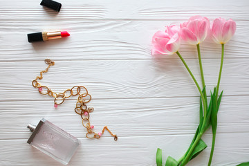 Wooden white background,perfume, jewelry, gifts and  tulips. Conception holiday, March 8, Mother's Day.