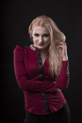 Fototapeta premium Seductive woman with long blonde hair and dressed in blouse