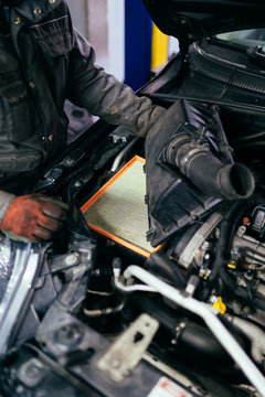 Auto mechanic repairing car. Selective focus. 