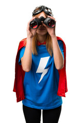 Pretty superhero girl with binoculars © luismolinero
