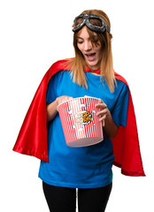 Pretty superhero girl eating popcorns