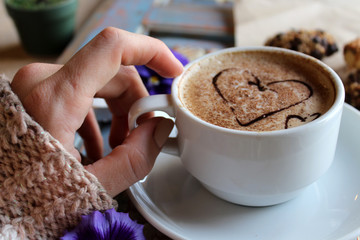 morning cappuccino with hearts, with cookies and flowers