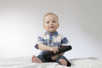 An infant child with karaoke microphone