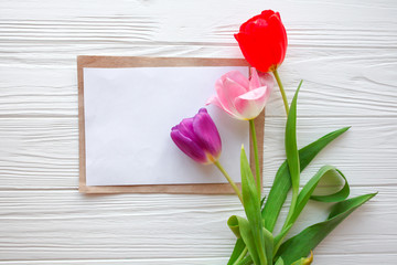 Wooden white background,letter and  tulips.  March 8, Mother's Day.