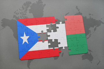 puzzle with the national flag of puerto rico and madagascar on a world map