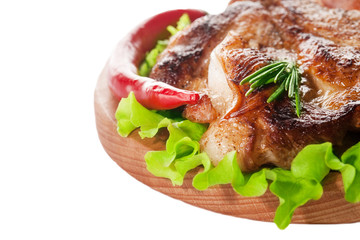 fried steak on a wooden board on a white background